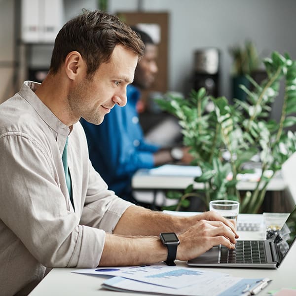 Man at office laptop learning about citation building