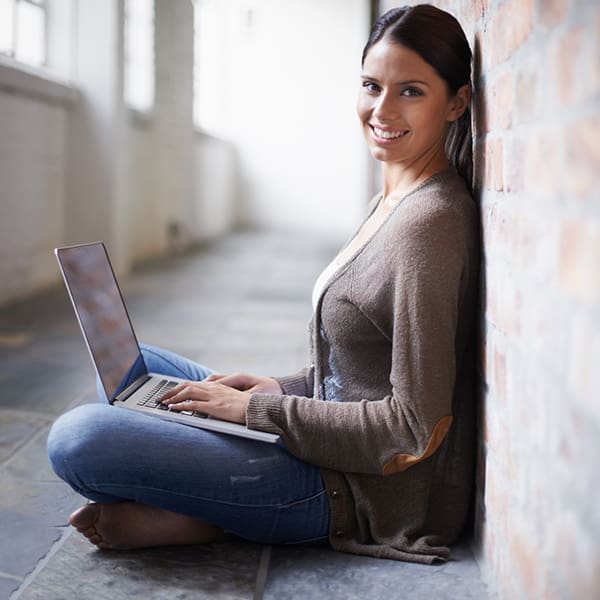 Woman on laptop reading about how much does SEO cost