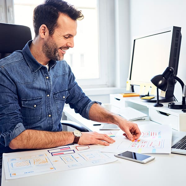How to Choose a Web Design Company 4 A man working at his desk thinking about how to choose a web design company