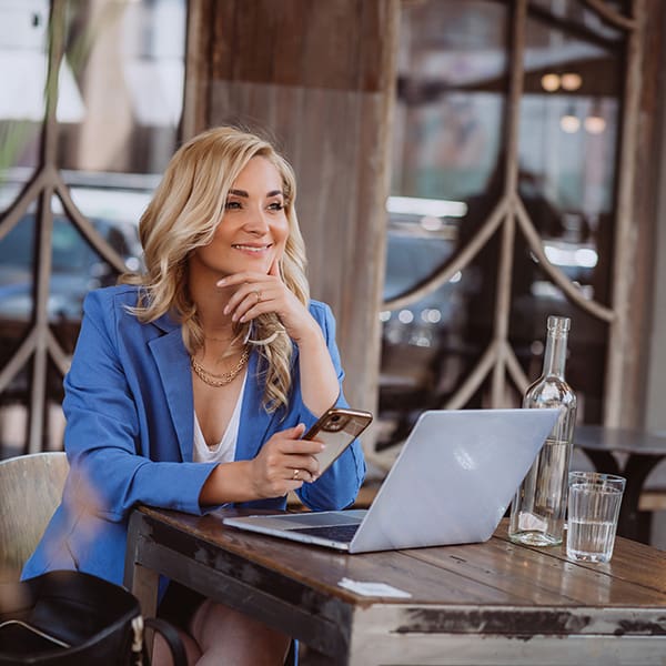 Woman on laptop learning how to add meta description in WordPress